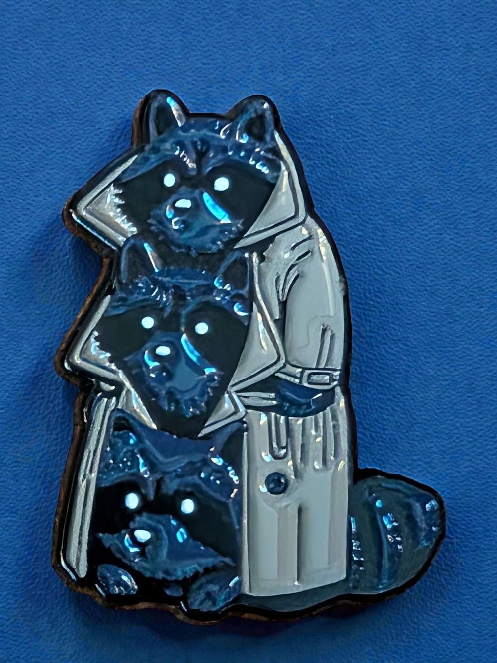 Three Raccoons in a Trench Coat Enamel Pin